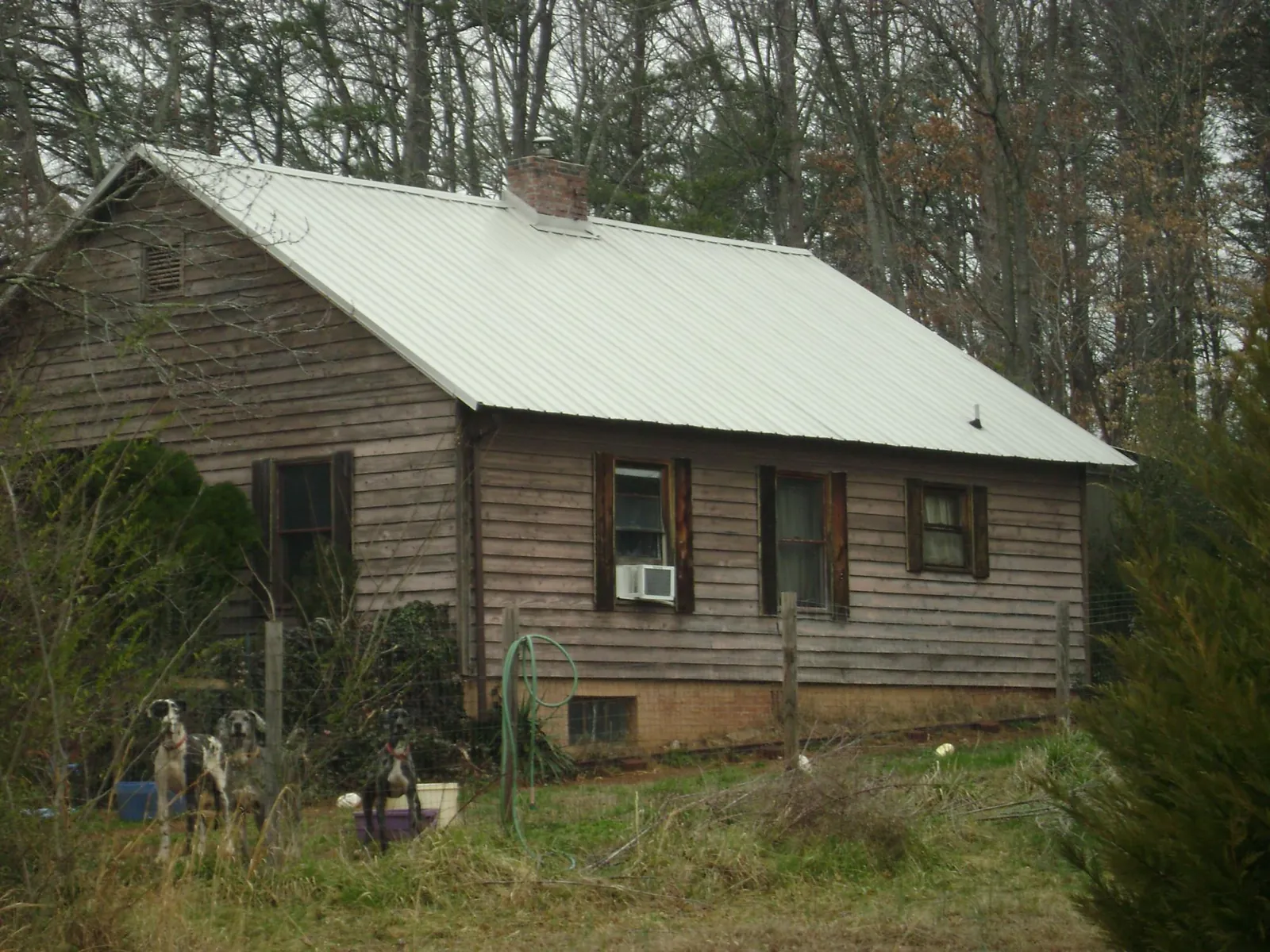 White metal roof on an old wood sided farmhouse, from a Metal Roof Installation job in Gresham